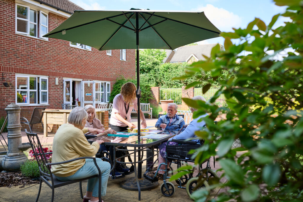 residents outside playing games around a table