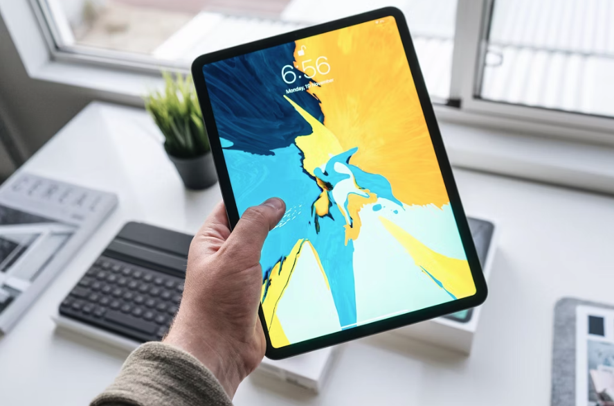 man holding a tablet in his hand