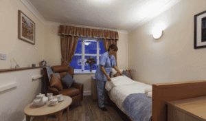 nurse making residents bed